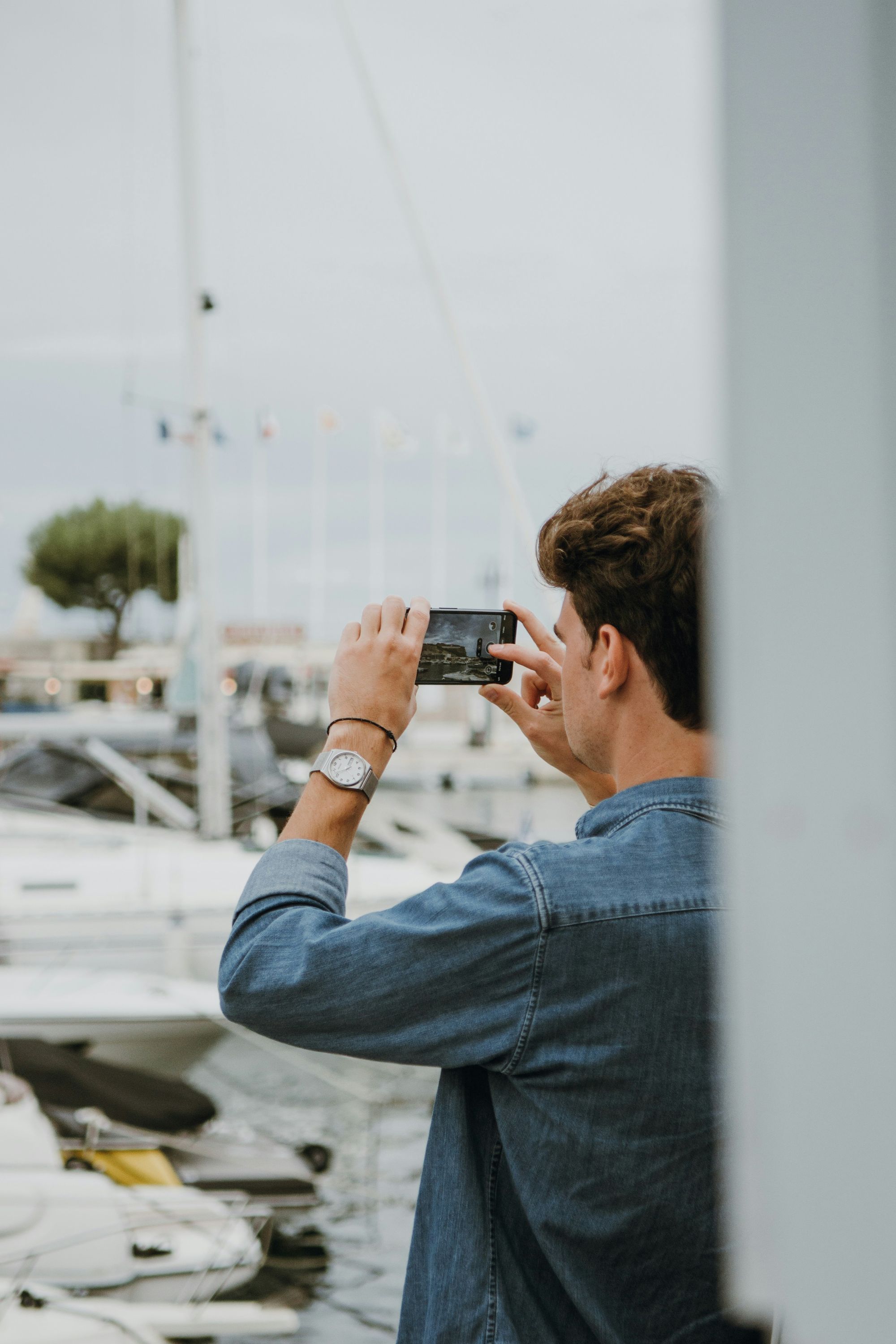 A man clicking a picture on his iphone