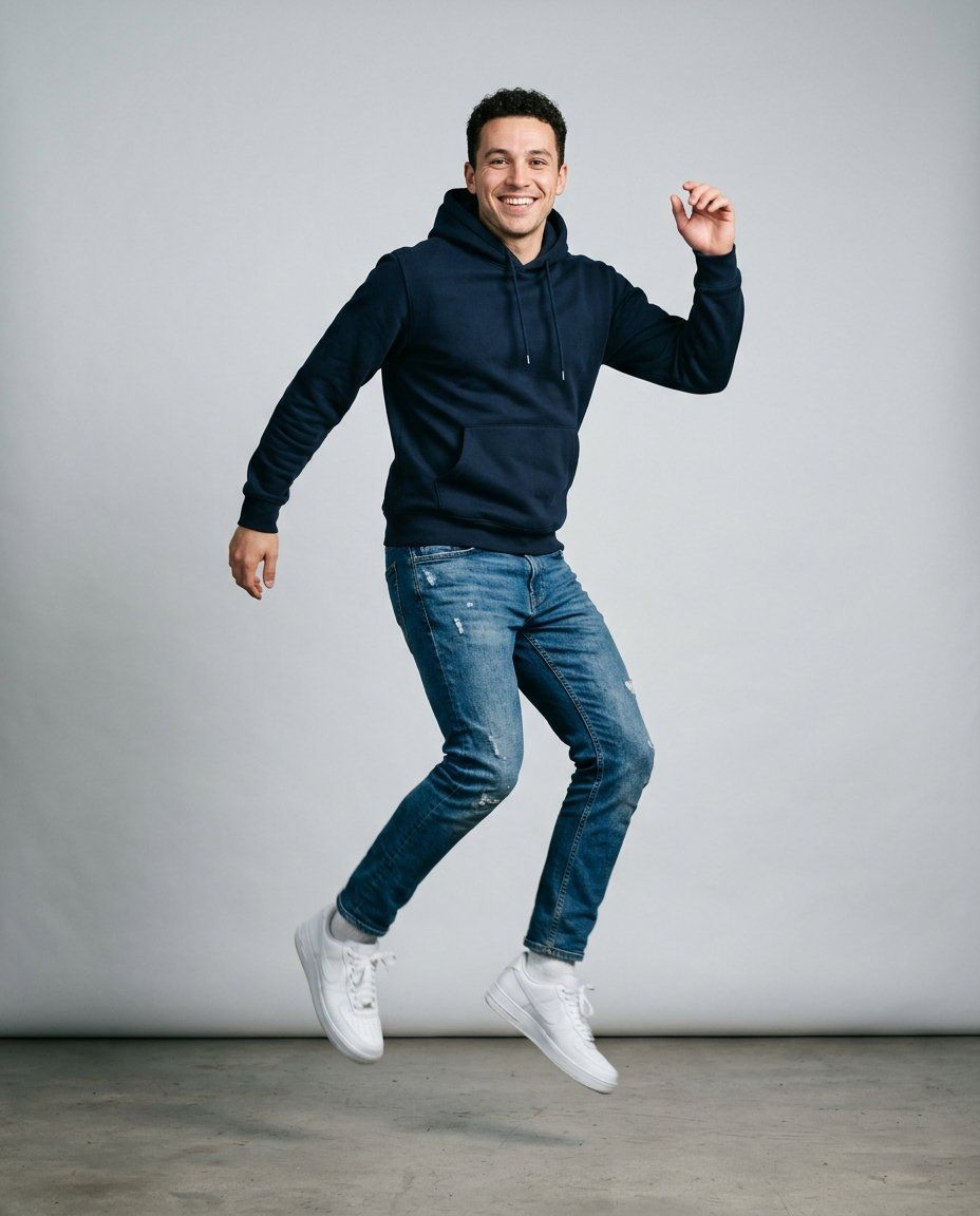 A man in his twenties in a hoodie and sneakers, full-length